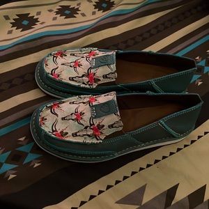 Brand new size 8 Ariat slip on shoes, blue with cow head print